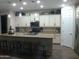 Island kitchen with granite countertops and stainless steel appliances at 26035 W Quail Ave, Buckeye, AZ 85396