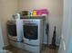 Laundry room with washer, dryer, and overhead shelving at 26035 W Quail Ave, Buckeye, AZ 85396