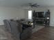 Spacious living room with hardwood floors, fireplace, and large TV at 26035 W Quail Ave, Buckeye, AZ 85396