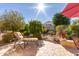 Relaxing backyard patio with seating area, umbrella, and landscaping at 26541 W Ross Ave, Buckeye, AZ 85396