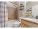 Clean bathroom with shower/tub combo, updated vanity, and striped shower curtain at 26541 W Ross Ave, Buckeye, AZ 85396