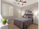 Guest bedroom with ceiling fan and window shutters at 26541 W Ross Ave, Buckeye, AZ 85396