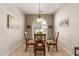 Dining area with glass top table and wood chairs, near kitchen at 26541 W Ross Ave, Buckeye, AZ 85396