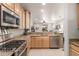 Bright kitchen with granite countertops and stainless steel appliances at 26541 W Ross Ave, Buckeye, AZ 85396