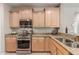 Modern kitchen features stainless steel appliances and light wood cabinetry at 26541 W Ross Ave, Buckeye, AZ 85396