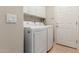 Bright laundry room with washer, dryer, and cabinets at 26541 W Ross Ave, Buckeye, AZ 85396