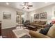 Living room with hardwood floors, a sofa, and access to a patio at 26541 W Ross Ave, Buckeye, AZ 85396