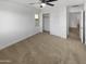 Bright bedroom with ceiling fan, closet, and access to hallway at 2708 N Heritage St, Buckeye, AZ 85396