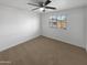 Bright bedroom with ceiling fan and window coverings at 2708 N Heritage St, Buckeye, AZ 85396