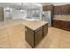 Open kitchen with island and view into living room at 2708 N Heritage St, Buckeye, AZ 85396