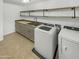 Laundry room with washer, dryer, cabinets, and shelving at 2708 N Heritage St, Buckeye, AZ 85396
