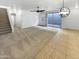 Bright living room with tile and carpet flooring, sliding glass door to backyard at 2708 N Heritage St, Buckeye, AZ 85396