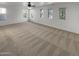 Bright main bedroom with carpeted floors and multiple windows at 2708 N Heritage St, Buckeye, AZ 85396