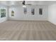 Bright main bedroom with carpeted floors and multiple windows at 2708 N Heritage St, Buckeye, AZ 85396