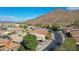 Neighborhood view with houses, desert landscape, and a mountain in the distance at 27194 N Skipping Rock Rd, Peoria, AZ 85383