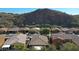 Aerial perspective of houses nestled against a mountain backdrop at 27194 N Skipping Rock Rd, Peoria, AZ 85383