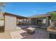 Spacious backyard with covered patio, fire pit, and built-in BBQ at 27194 N Skipping Rock Rd, Peoria, AZ 85383