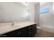 Modern bathroom with patterned tile and a window at 27194 N Skipping Rock Rd, Peoria, AZ 85383