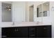 Bathroom with double vanity and dark cabinets at 27194 N Skipping Rock Rd, Peoria, AZ 85383