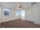 Spacious bedroom with ceiling fan and carpet flooring at 27194 N Skipping Rock Rd, Peoria, AZ 85383