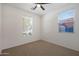 Bright bedroom with two windows and ceiling fan at 27194 N Skipping Rock Rd, Peoria, AZ 85383