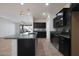 Kitchen with dark cabinets, granite countertops, and stainless steel appliances at 27194 N Skipping Rock Rd, Peoria, AZ 85383