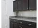 Kitchen features dark cabinets and granite countertops at 27194 N Skipping Rock Rd, Peoria, AZ 85383