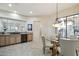 Bright breakfast nook with glass table and four chairs, adjacent to kitchen at 30994 N 74Th Way, Scottsdale, AZ 85266