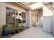 Front entry with a wooden door and potted plants at 30994 N 74Th Way, Scottsdale, AZ 85266