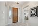 Bright entryway with wood door and view to dining area at 30994 N 74Th Way, Scottsdale, AZ 85266