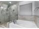 Relaxing bathroom with soaking tub, walk-in shower, and large window at 3496 E Anika Ct, Gilbert, AZ 85298