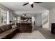 Living room, hardwood floors, brown sectional couch, kitchen view at 3496 E Anika Ct, Gilbert, AZ 85298