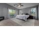 Spacious main bedroom with a king-size bed and access to a private balcony at 3496 E Anika Ct, Gilbert, AZ 85298