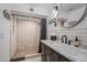 Updated bathroom with patterned tile shower and dark vanity at 37209 N 12Th St, Phoenix, AZ 85086