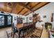 Rustic dining area with large wood table and wood ceiling beams at 37209 N 12Th St, Phoenix, AZ 85086