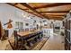 Dining room features a large rustic table and adjacent kitchen at 37209 N 12Th St, Phoenix, AZ 85086