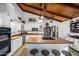 Bright kitchen with white cabinets, an island, and wood-beamed ceiling at 37209 N 12Th St, Phoenix, AZ 85086