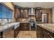 Kitchen with corner sink, granite counters, and dark wood cabinets at 37209 N 12Th St, Phoenix, AZ 85086