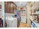 Laundry room with washer, dryer, shelving, and extra storage at 37209 N 12Th St, Phoenix, AZ 85086