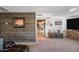 Living room with wood accent wall, sectional sofa, and view into kitchen at 37209 N 12Th St, Phoenix, AZ 85086