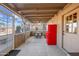 Covered patio with seating area and red refrigerator at 37209 N 12Th St, Phoenix, AZ 85086