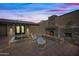 Outdoor patio with fireplace, seating, and landscaping at 37209 N 12Th St, Phoenix, AZ 85086