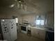 Bright kitchen with white cabinets and appliances at 3721 N Illinois Ave, Florence, AZ 85132