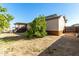 Backyard view showcasing a lemon tree and shed at 3810 W Mohawk Ln, Glendale, AZ 85308