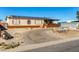 Single-wide manufactured home with solar panels and a gravel driveway at 3810 W Mohawk Ln, Glendale, AZ 85308