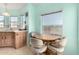 Bright kitchen with wood cabinets and a small dining area at 3810 W Mohawk Ln, Glendale, AZ 85308