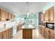 Kitchen with light-colored cabinets, island, and stainless steel appliances at 3810 W Mohawk Ln, Glendale, AZ 85308