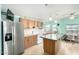 Kitchen with an island, stainless steel appliances, and light-colored cabinets at 3810 W Mohawk Ln, Glendale, AZ 85308