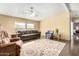 Spacious living room with brown sofas, area rug, and ceiling fan at 3810 W Mohawk Ln, Glendale, AZ 85308