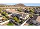 Aerial view of a house with a large backyard and mountain views at 3818 N Lomond Cir, Mesa, AZ 85215